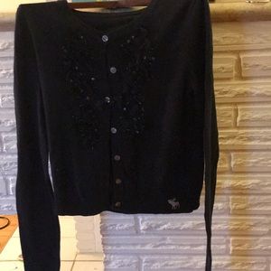 Blue sweater with flowers in front